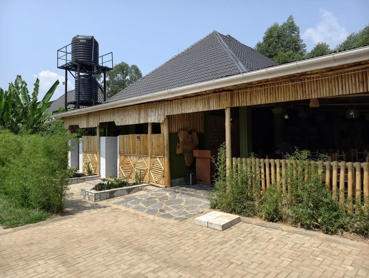 Ishasha Junction Hotel exterior among lush gardens